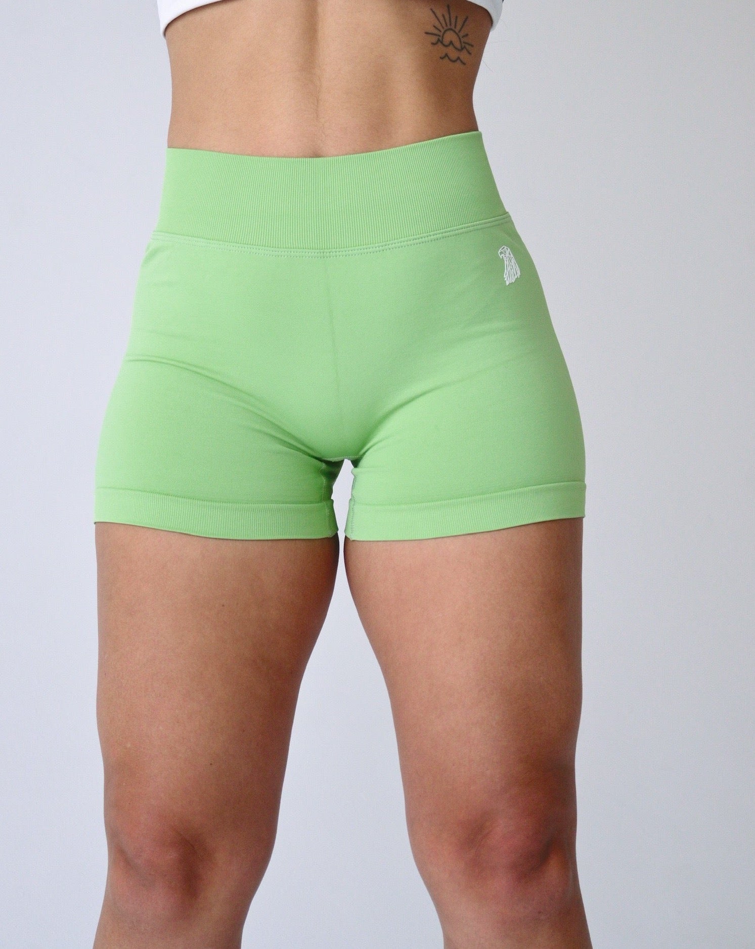EHANCE Seamless Shorts - KIWI - Libera Fitness Apparel. Flattering v-cut waistband and 3-inch inseam for optimal comfort and flexibility during workouts. Ideal for enhancing curves.