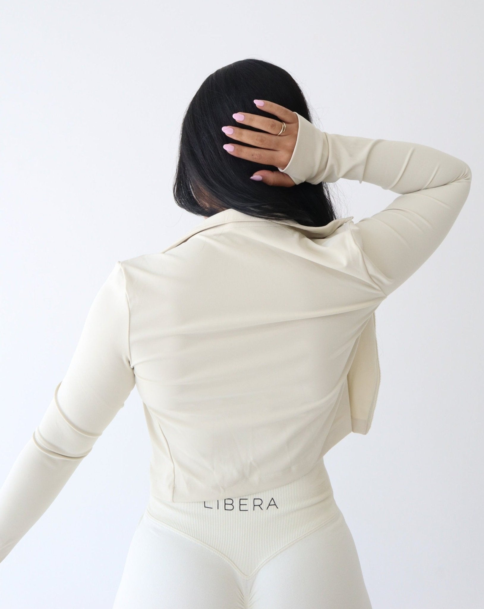 REFINE Cropped Training Jacket - CREAM - LIBERA Fitness Apparel. Upgrade your activewear with our REFINE Cropped Training Jacket. Stay dry during workouts with moisture-wicking fabric.